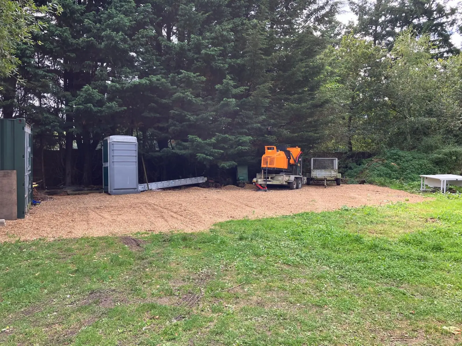 Wood chipping machine processing tree waste on site in South Bucks